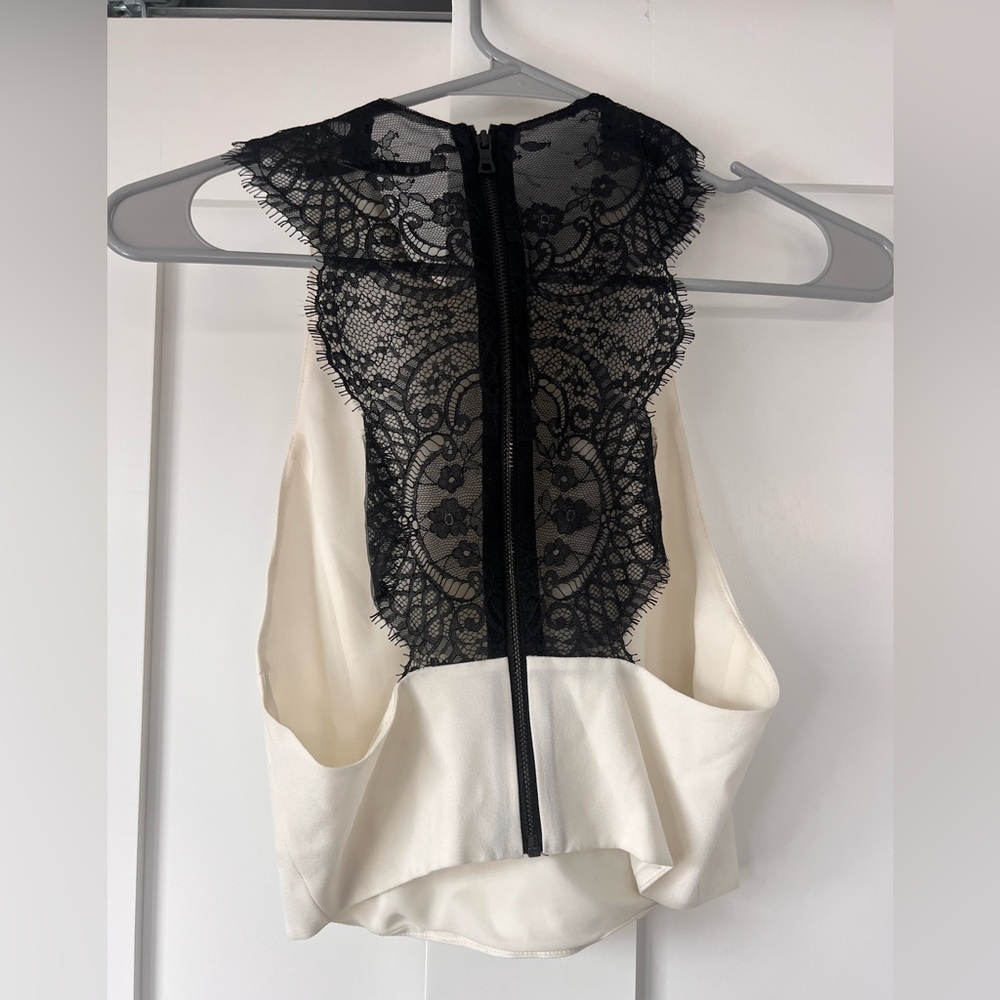 Alice and Olivia size 6 white crop top with a black lace back.